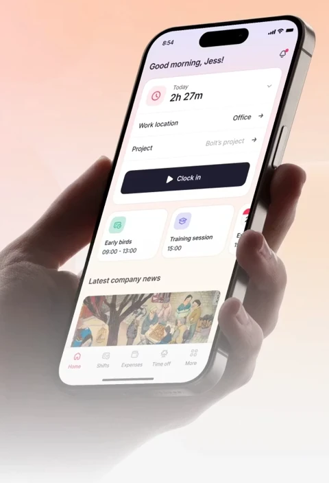A hand holding a phone with the Factorial mobile app showing today's hours and a clock in button